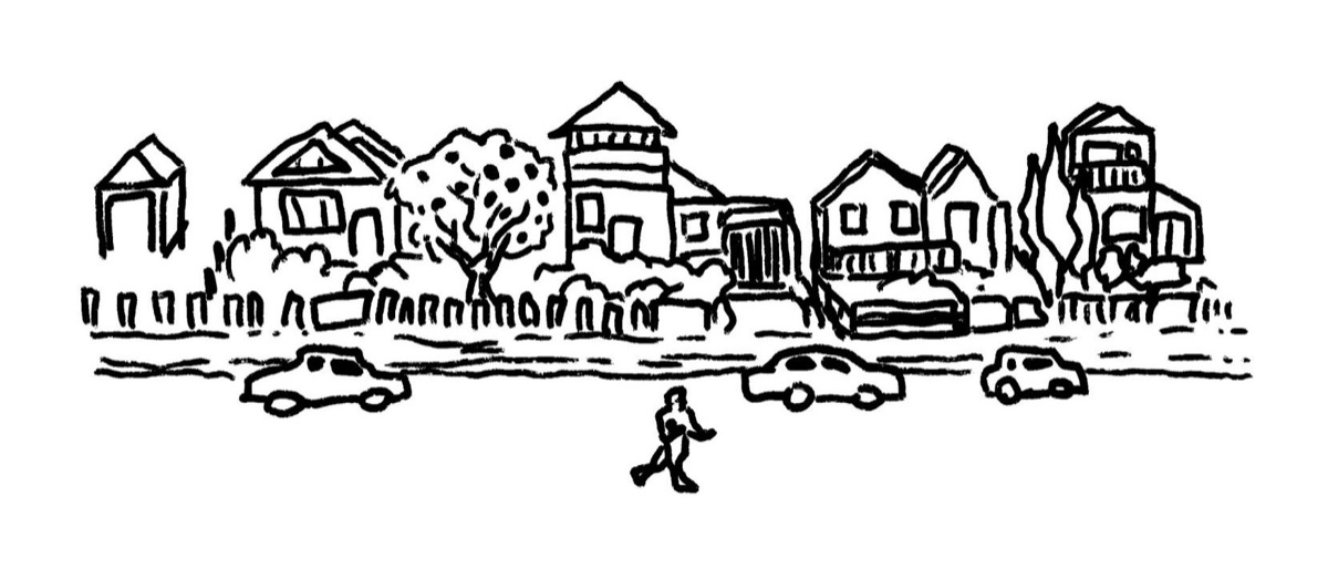 A street of houses and front gardens, with a small figure walking past parked cars.